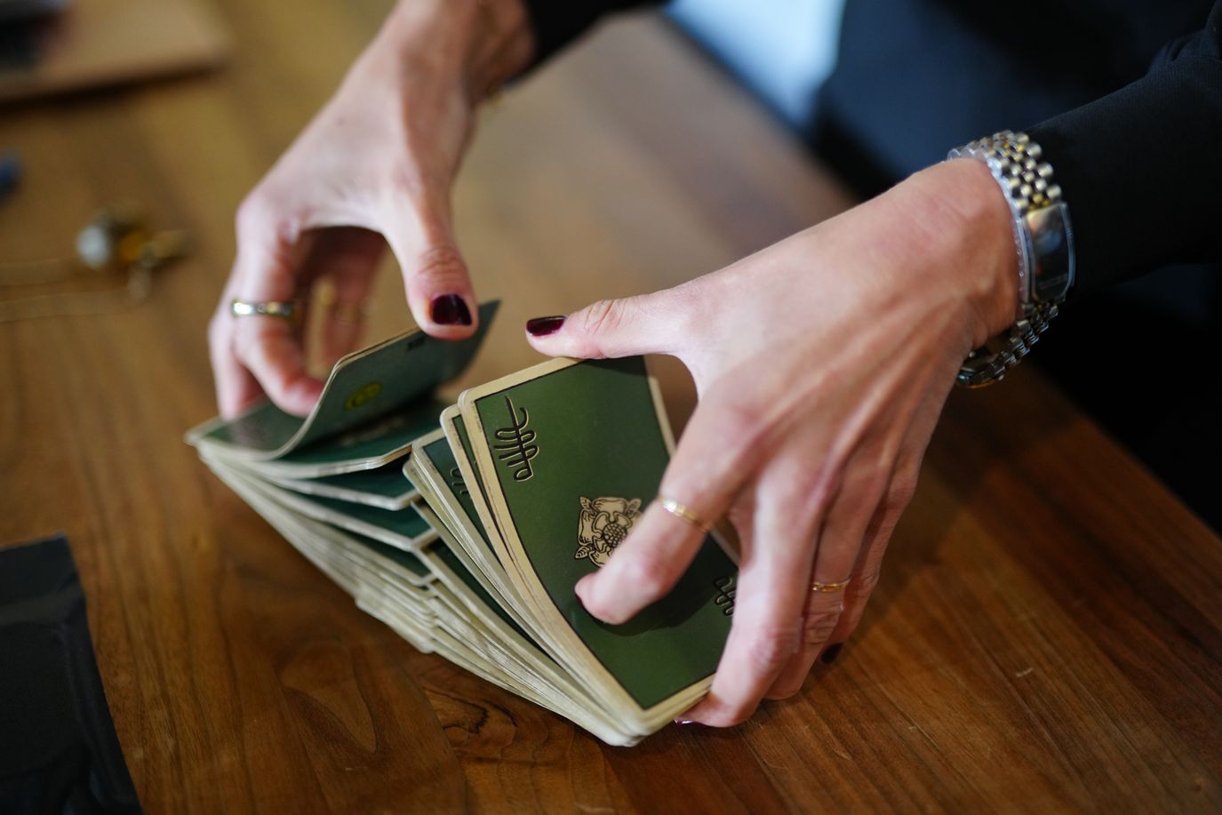 Hands shuffling tarot cards